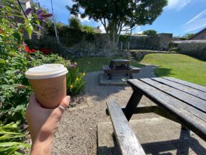 A cozy corner of The Coffee Hut, the best coffee spot in Helston, where locals and visitors enjoy exceptional coffee and a warm ambiance.