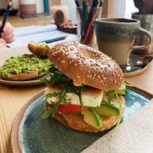A barista pouring a rich, creamy coffee, showcasing the premium coffee offerings available at The Coffee Hut in Helston.