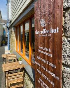 A cozy corner of The Coffee Hut, the best coffee spot in Helston, where locals and visitors enjoy exceptional coffee and a warm ambiance.